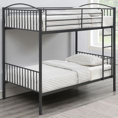 a black metal bunk bed with two white pillows on the bottom and one is empty