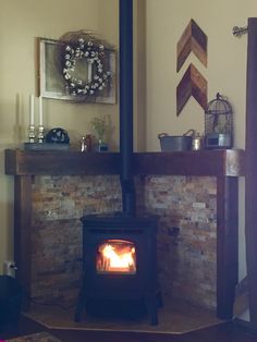 a wood burning stove sitting inside of a living room next to a firewood log