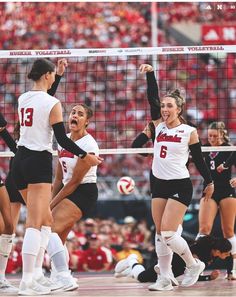 the volleyball team is celebrating their victory over the crowd