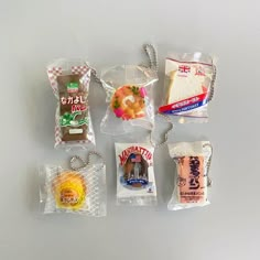 six packaged food items are displayed on a white surface