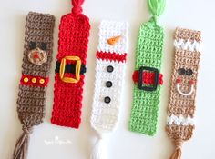 four crocheted christmas bookmarks are lined up