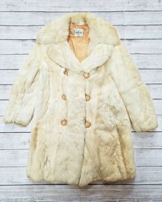 1950s KAPLAN'S CHICAGO TRUE VINTAGE FOX FUR CREAM WARM COAT MEDIUM MD. Shipped with USPS Priority Mail. 1950s Kaplan's Chicago Fox (?) Tan Fur Coat, not 100% sure if it's fur, but it's a fur Fully lined, the lining has loose stitching on inside right bottom (as shown). Bakelite buttons with elastic closure. Some wear by second button (as shown). Small discoloration on bottom left (as shown) and bottom back right (as shown). Slight dinginess at wrists (as shown). Please ask if you have any questi Vintage Winter Outerwear, Vintage Cream Fur Coat For Winter, Vintage Cream Outerwear With Button Closure, Cream Vintage Fur Coat For Winter, Fox Tan, Bakelite Buttons, Vintage Fox, Warm Coat, Fox Fur