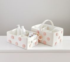 two white baskets with pink polka dots on them and the words pottery barn kids written below