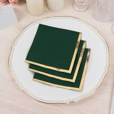 three green napkins on a white plate