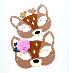 a paper mask with a flower on it and two deer's face cut out