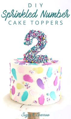 a birthday cake with sprinkled numbers on it and the number two in the middle