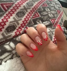 Celebrate the holiday season in style with these cute Christmas nails and designs, including festive nail art ideas that you can DIY at home! Short Almond French Tip Nails Christmas, Christmas Nails Acrylic Almond Red, Red French Tip With Bow, Almond Red French Tip, Red French Tip Nails Christmas, Almond Red French Tip Nails, Christmas Nails Short Almond, Almond Shaped Christmas Nails, Red French Tip Nails Almond