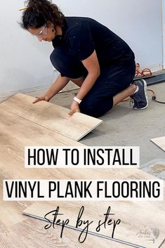 a woman kneeling down on the floor installing vinyl planks