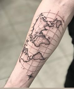 a man's arm with a world map tattoo on the left side of his arm