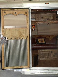 an open door on the inside of a horse trailer that is parked in a garage