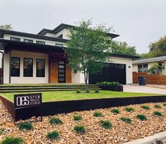 a modern house with landscaping in the front yard