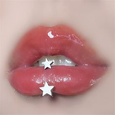 a close up view of a person's lips with stars on them