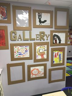 the wall is covered with pictures and letters that spell out gallery on it, along with other children's artwork