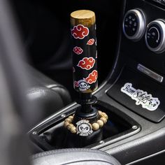 the steering wheel knob is decorated with red and black flowers