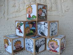 a set of six wooden blocks with cartoon characters on them, all stacked up in the shape of a pyramid