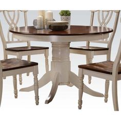 a dining table with four chairs around it