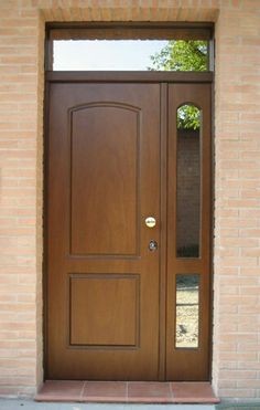 a dog is standing in front of a door that has glass panels on the side