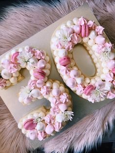 two cookies decorated with pink and white flowers