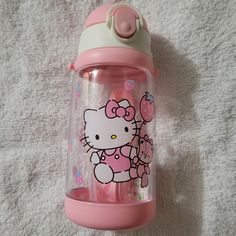 the hello kitty sippy cup is pink and green