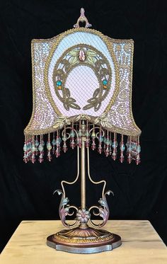 a table lamp with beading on top of it