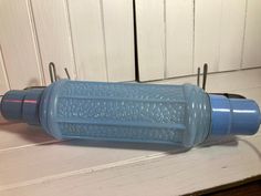 a blue water bottle sitting on top of a white counter