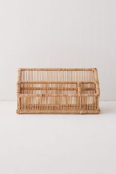 a wicker basket sitting on top of a white table