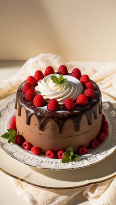 a chocolate cake with raspberries and whipped cream on top, sitting on a plate