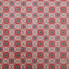 a red and blue patterned fabric with small white flowers on the bottom right corner,