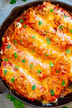 a casserole dish with meat and cheese in it, garnished with parsley