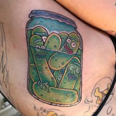 a woman's thigh with an image of cartoon characters in a jar on it