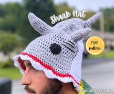 a man wearing a crocheted hat with a cat on it