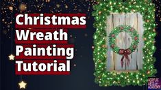 the christmas wreath painting is being displayed in front of a wooden frame with lights on it