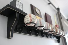 baseballs are lined up on a shelf in a room