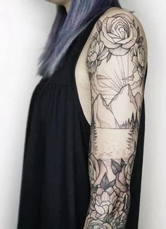 a woman with blue hair and tattoos on her arm