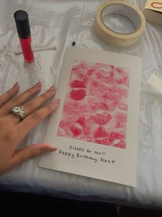 a woman's hand is shown next to a birthday card and some crafting supplies