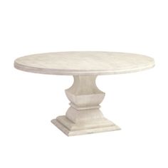 a white marble dining table with pedestals