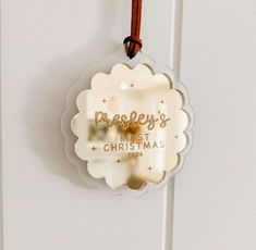 a christmas ornament hanging on a door with the words peddley's first christmas