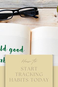 an open book sitting on top of a wooden table next to glasses and a pen