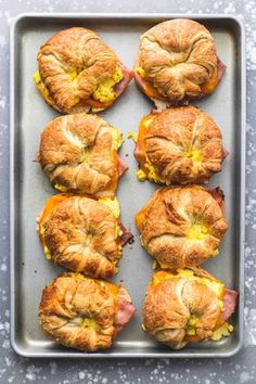 ham and cheese croissants on a baking sheet