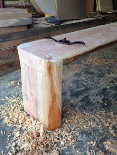 a wooden bench sitting on top of a pile of wood