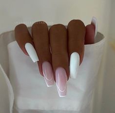 a woman's hand with white and pink manies