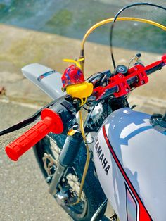 the handlebars on this motorcycle are red and yellow