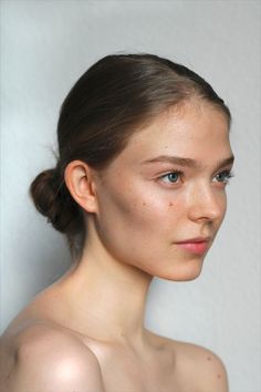 a young woman with freckled hair and blue eyes is looking at the camera