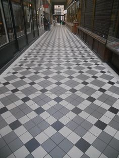 a black and white checkered floor in an empty shopping mall