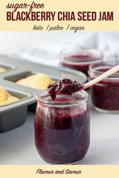 a jar filled with jam next to muffins