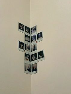 a white wall with pictures hanging on it