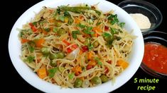 a white bowl filled with noodles and vegetables next to two bowls of dipping sauces