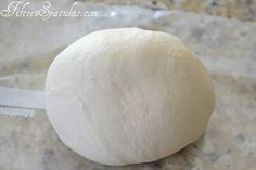 a ball of dough sitting on top of a counter