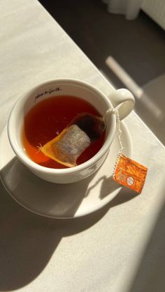 a white bowl filled with soup on top of a table next to an orange tag