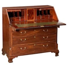 an old fashioned wooden desk with drawers